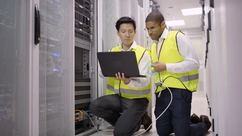 4K I.T. Engineers checking the servers with laptop in a data center Stock Footage 75060742