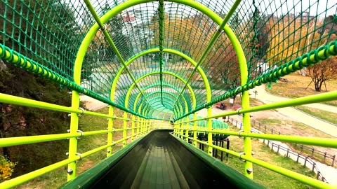 4K Japan's Autumn Sliding Down a slide at a Park POV Stock Footage 255990194