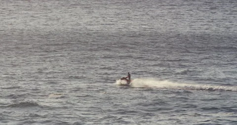 4K of jet ski bringing professional surfer on open sea to ride big waves Stock Footage 163087930
