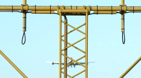 4K Jumbojet on approach behind lamp posts Stock Footage 34995772