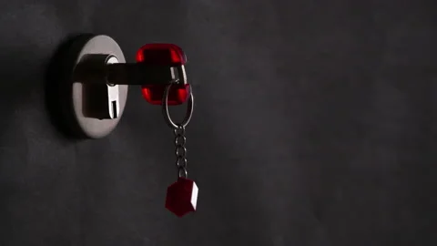 4K - Key is inserted into the lock on a black background Stock Footage 163226599