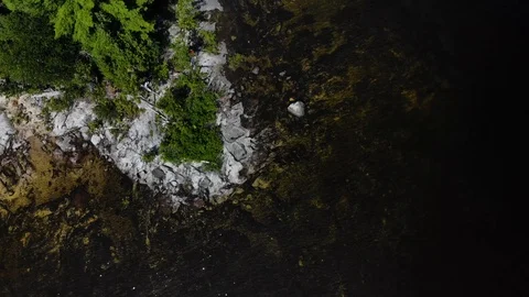 4K lake aerial drone flying forward over island shore Stock Footage