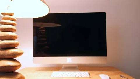 4K lampshade turning on at school desk computer, big screen work station Stock Footage 88501002