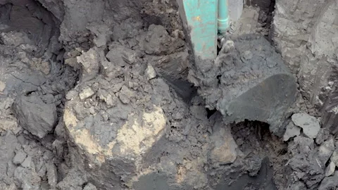 4k, A large backhoe is digging in a hole. Prepare to load soil into trucks fo Stock Footage 199064535