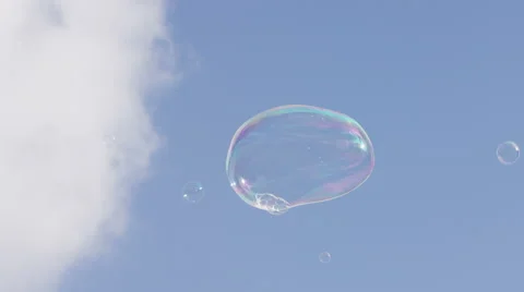 4K Large bubble floats in the sky above before bursting, in slow motion Видео 55887241