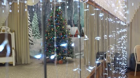 4K. A large Christmas tree is shown through a mirrored wall. Stock Footage 229839330