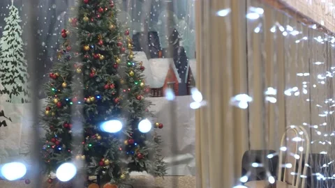 4K. A large Christmas tree is shown through a mirrored wall. Stock Footage 229839369