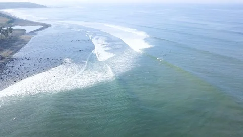 4K Large group of unknown surfers riding waves over dangerous reef Stock Footage 115506716