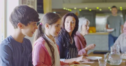 4K Large happy family group eating a meal together at home Stock Footage