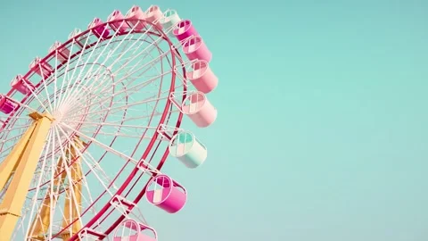 4K Large Red and White Ferris Wheel Pastel Pink and Teal Passenger Cars Stock Footage 330480090