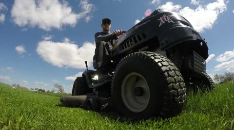4k lawn tractor super closeup while cutting grass Stock Footage 50063252