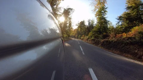 4K LD Back of the car reflecting sunlight while driving on a road Stock Footage 118547040