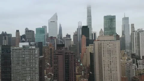 4K Left Lateral Aerial low to high NYC Midtown East Skyline on Overcast Morning Stock Footage