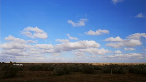 4K Light clouds in a blue sky over a field. Windy autumn sky. Stock Footage 97041233