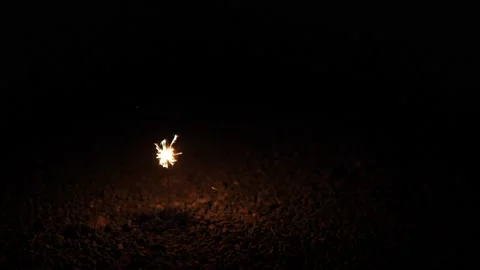 4K Light of sparkler on ground isolated dark night background Video stock 146217690