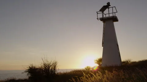 4K: Lighthouse on Coast At Sunset Lock-off Background Plate Stock Footage 65777448