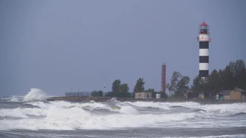4K - Lighthouse on the seashore at storm Stock Footage 142027946