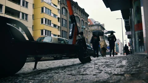 4k: Lime Electric E scooters on sidewalk ready for ride in rainy Berlin, Germany Stock-Footage 132177601