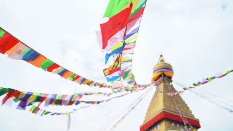 4K Lines of multicolored flags stemming from Buddhist stupa flutter in wind Stock Footage 131291890