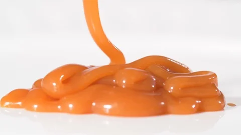 4K - Liquid caramel on a white background. Sweet candy Stock-Footage 119652114