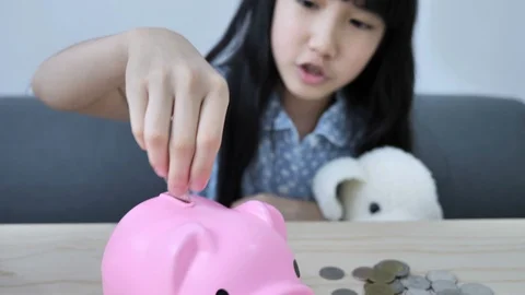 4K Little Asian girl putting money coin Stock Video Pond5