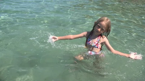 4K Little Girl Dancing Playing on Beach Stock Video Pond5
