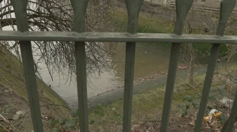4k Locked Gate In Front Of Abandoned Overgrown Steps Down To River Thames Stock Footage
