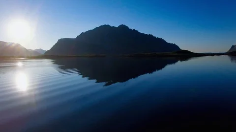 4K Lofoten - Mirror reflection of setting sun, ocean and mountains Stock Footage 93888595