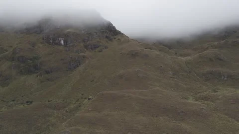 4K Log Drone Flying Sideways Revealing Brown Mountain in Clouds Cuenca Ecuador Stock Footage 277210948