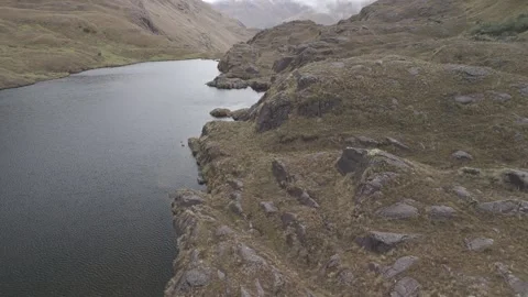 4K Log Drone Flying Sideways Revealing Lake on Brownyish Mountains Ecuador Stock Footage 277211053