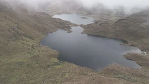 4K Log Drone Flying towards Two Lakes in High Mountains with Clouds Ecuador Stock Footage 277210753