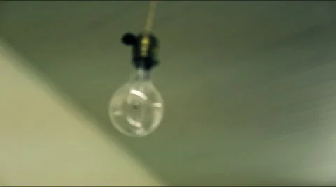 4K Lone lightbulb dangling on string Stock Footage 45674045