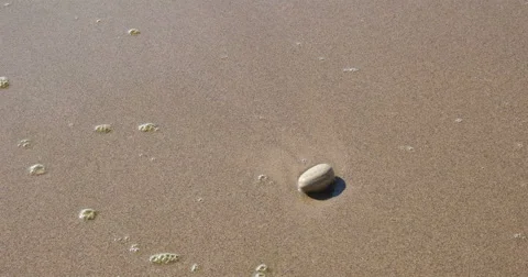 4K Lone Rock Washed by Waves on Sandy Beach Stock Footage 46032107