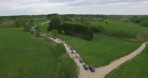 4K Long car queue on gravel road Stock Footage 67446486