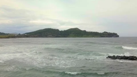 4K Long-distance Drone Side View of Mt. Songaksan (송악산), Jeju Volcanic Island Stock Footage 143864078