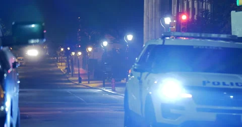 4K LONG SHOT EMPTY CITY STREET WITH POLICE CAR AT NIGHT Stock Footage 131108249