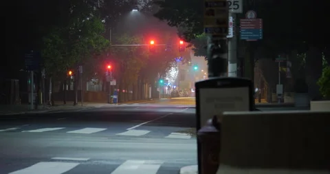 4K LONG SHOT OF EMPTY CITY STREET WITH A SILENT AMBULANCE PASSING Video stock 131124224