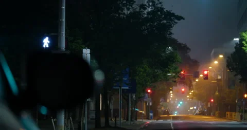 4K LONG SHOT EMPTY CITY STREET AT NIGHT RACK FOCUS FROM CAR Stock Footage 131124914