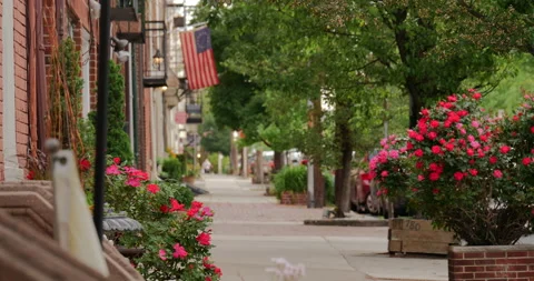 4K LONG SHOT EMPTY CITY SIDEWALK WITH FLOWERS AND BETSY ROSS FLAG Stock Footage 131278732