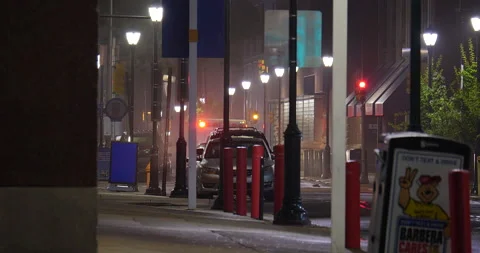 4K LONG SHOT OF EMPTY SIDEWALK AT NIGHT WITH AMBULANCE LIGHTS Stock Footage 131127045