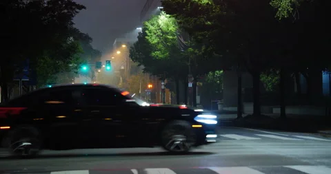 4K LONG SHOT EMPTY STREET AT NIGHT WITH TWO CARS PASSING THROUGH Stock Footage 131124259