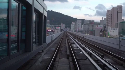 4K Looking out of window of a moving metro car train tracks in city of Busan-Dan Stock Footage