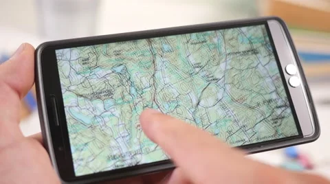 4K Looking at a Topographic Map Plan on Smartphone Touchscreen Stock Footage 67454298