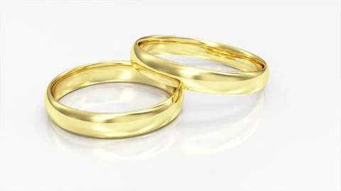 4K Loop Animation of Golden Wedding Rings on white reflective background Stock Footage 100764714