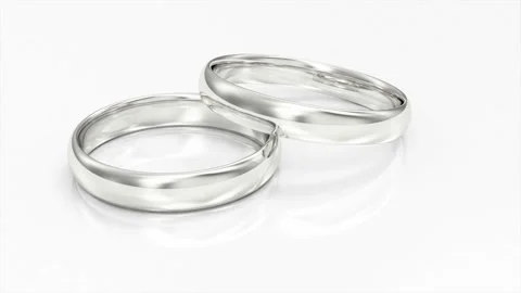 4K Loop Animation of White Gold Wedding Rings on white reflective background Stock Footage 100765199