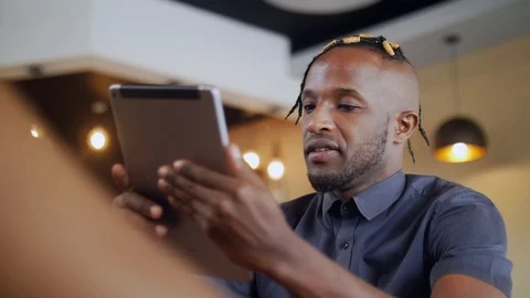 4k low angle extreme close up of businessman using tablet in the coffee shop. Stock Footage 111331860