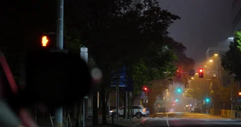 4K LOW ANGLE LONG SHOT OF HAZY STREET AT NIGHT Stock Footage 131125201