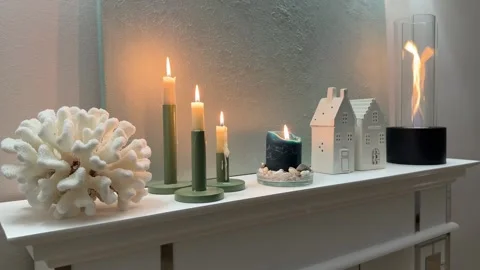 4K - Low Angle Medium Shot Of Cozy Fireplace Mantel Decor With Candles Video stock 345364105