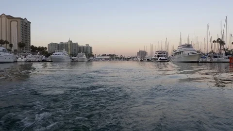 4K low angle shot of boat traveling through harbor in Marina del Rey, CA Video stock 77167498