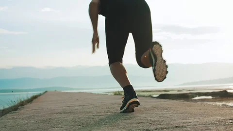 4K Low Angle Shot Of A Man Sprinting By The Seaside Stock Footage 93071776